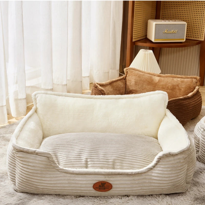 Plush rectangular dog bed with raised sides, soft cream fabric, in a cozy living room setting