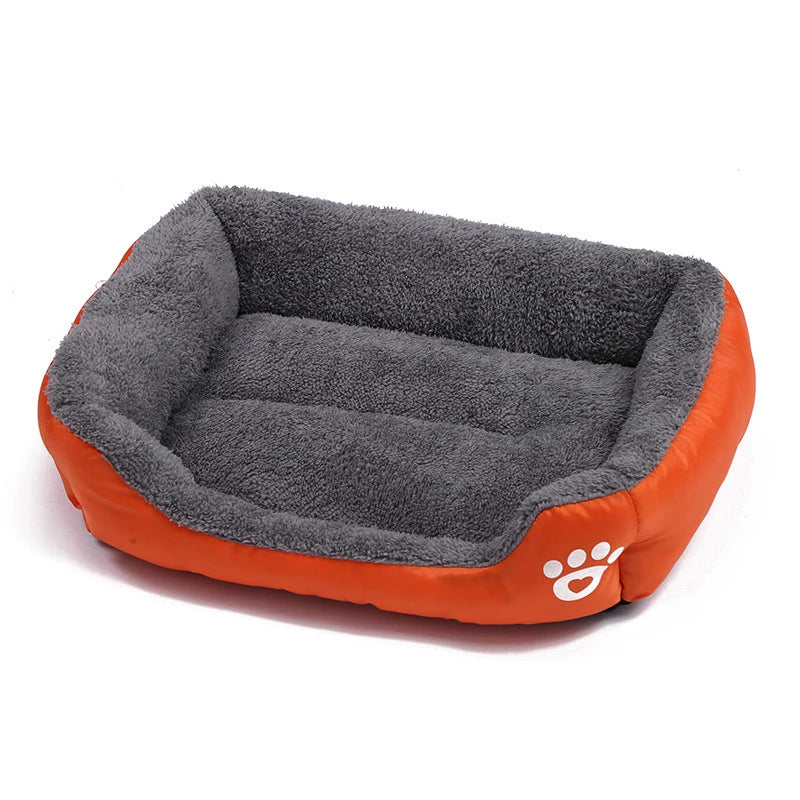 Rectangular gray plush dog bed with orange sides and white paw print, comfy pet bed