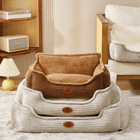 Stacked corduroy dog beds with plush lining in cozy living room setting