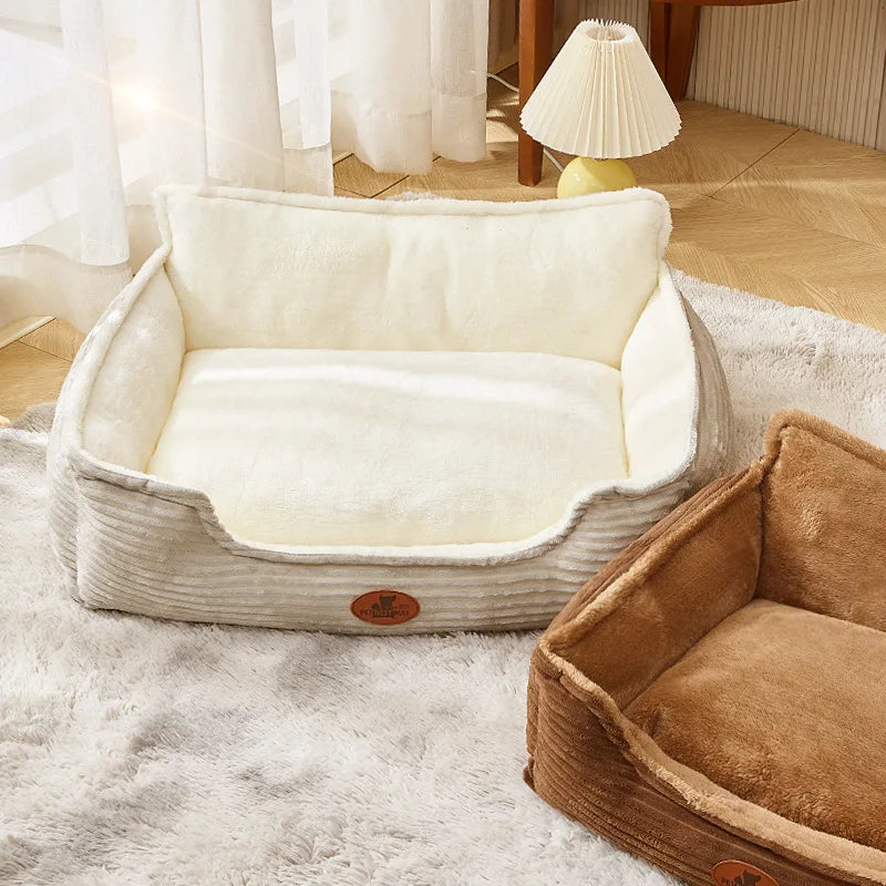 Plush rectangular dog beds in beige and brown on a soft rug in a cozy room
