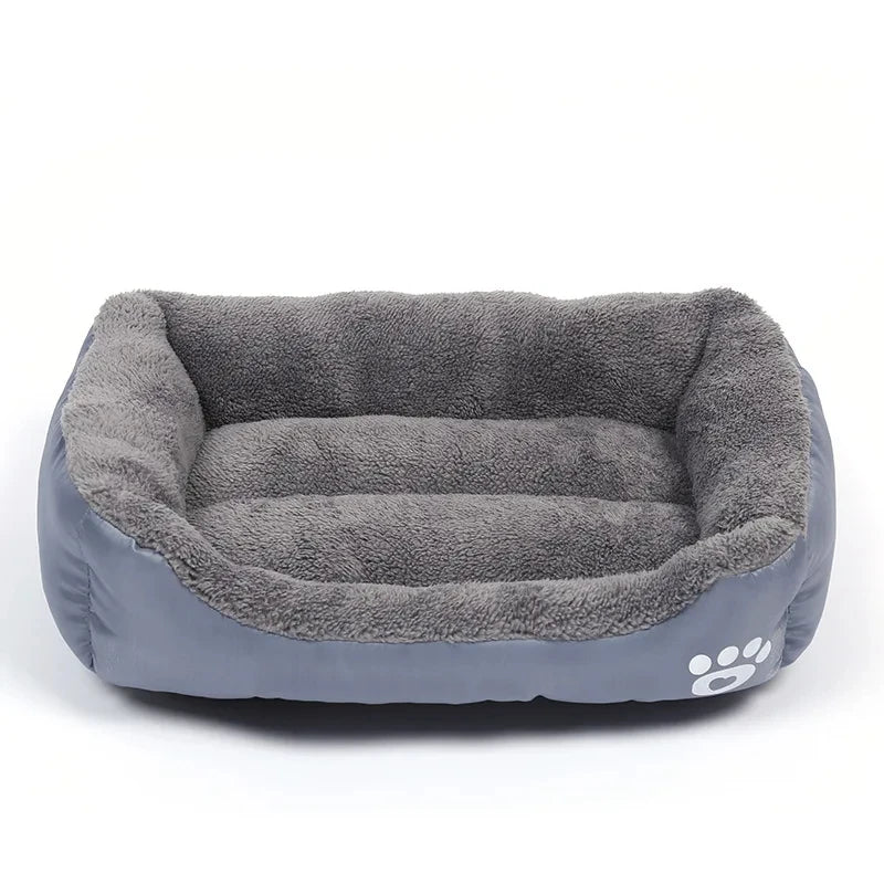 Soft grey rectangular dog bed with plush lining and paw print detail on the side